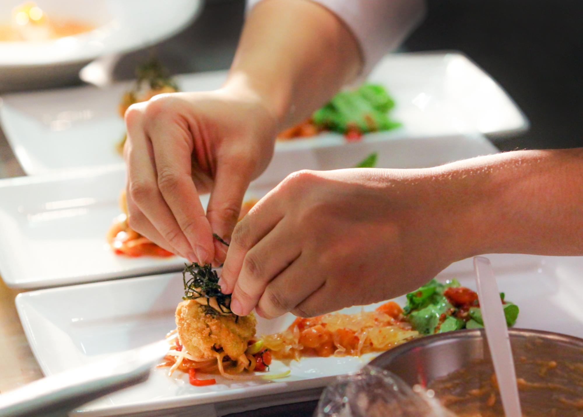 Chef plating quick-cook meal in a professional kitchen